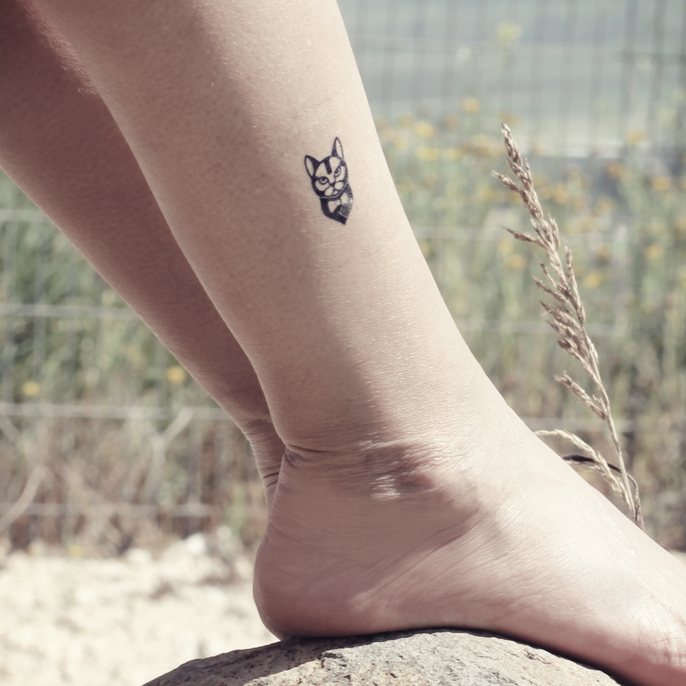 Minimalist cat tattoo on the ankle